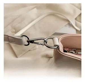 Detailed close-up of high-quality silver lobster clasp and D-ring on pink ballet tote bag