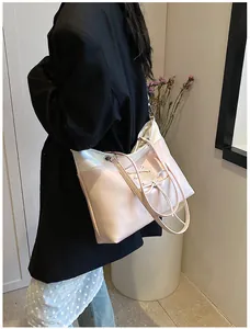 Detail of pink and cream contrast tote bag with ballet-style cross ribbon and bow detail