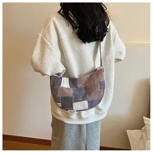Detailed back view of a woman wearing the patchwork canvas hobo bag showing its size