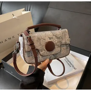 Detail of floral jacquard handbag with leather trim and silver metal hardware