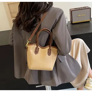 Macro detail of the contrast color stitching and premium PU leather on the tote bag
