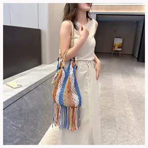 Detail of hand-woven hollow mesh shoulder bag with colorful stripes and long tassels