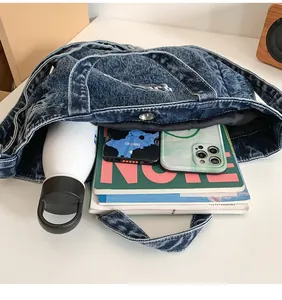 Spacious interior of washed denim tote bag filled with books and personal items