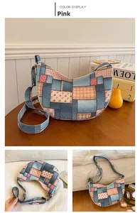 Detail of blue denim and pink floral patchwork shoulder bag with adjustable strap