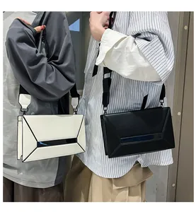 Detail showing high-capacity geometric crossbody bag in black and white styles