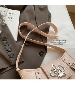 Close-up of stone texture shoulder bag with silver flower clasp and adjustable strap