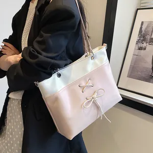 Minimalist ballet-style tote bag in white and pink contrast with ribbon bow detail