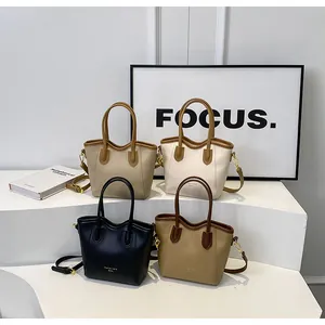 Detailed display of four contrast-color tote bags on minimalist display stands