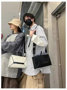 Detail of minimalist geometric crossbody bags in black and white with architectural lines