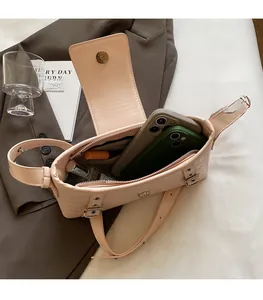 Internal view of beige stone pattern handbag showing space for phone and perfume