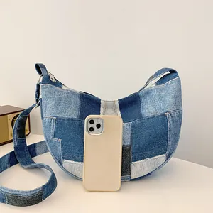 Blue denim patchwork crescent shoulder bag with retro geometric拼接 design and wide strap