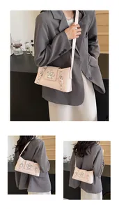 Detail view of pink crocodile pattern faux leather bag with vintage silver metal buckle
