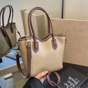 Minimalist beige and brown colorblock bucket bag with fashion trend print and strap