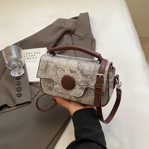 Retro landscape print handbag with brown leather straps and adjustable shoulder strap