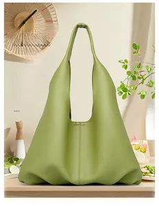 Close-up of grass green textured leather hobo bag with minimalist stitching detail
