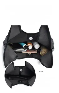 Detail view of black pebble leather tote bag showing large capacity interior with zipper pocket