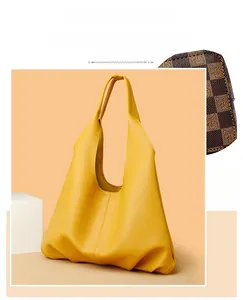 Detail of yellow lychee grain soft leather shoulder bag showing texture and drape