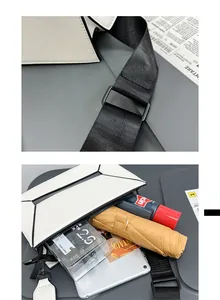 Detail view of large white geometric crossbody bag with ample space for tablet and umbrella