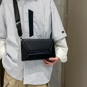 Minimalist black geometric crossbody bag with blue stripe detail and adjustable strap
