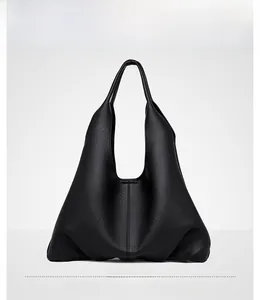 Detailed macro view of black large capacity tote bag featuring premium lychee grain leather
