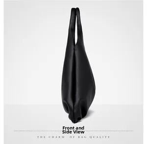 Side view of soft black pebbled leather tote bag with seamless minimalist design