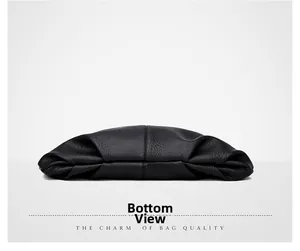 Detailed bottom view of the large black faux leather bag showing soft texture and stitching