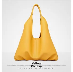 Detail view of large yellow hobo bag showing high-quality lychee texture and soft leather