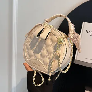 Chic quilted round crossbody bag in cream white with silk scarf handle and gold chain