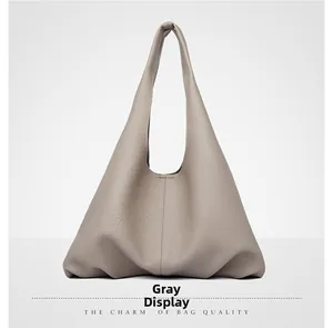 Detail shot of grey hobo bag showing soft lychee grain texture and minimalist design