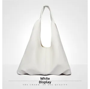 Detail view of white minimalist hobo bag featuring premium lychee grain leather texture