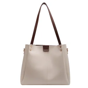 Large cream tote bag with brown straps and gold rivet details for women's fashion
