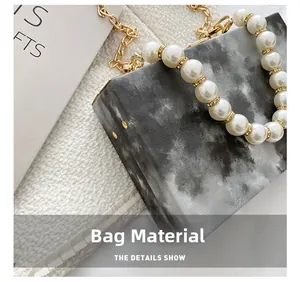 Close-up of marble pattern fabric and elegant faux pearl handle with rhinestone rings