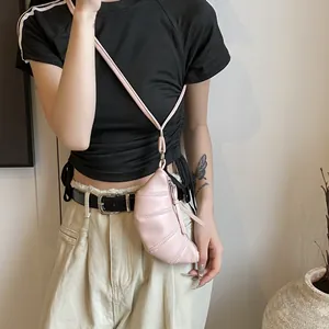 Detail view of pink mini croissant crossbody bag with quilted faux leather and silver zipper