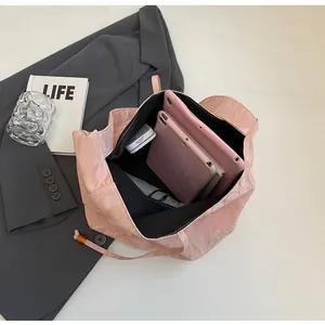 Vista superior del bolso tote rosa en charol plisado con gran capacidad para tabletas