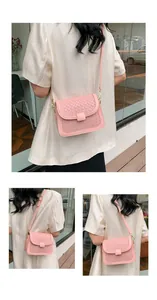 Close-up of pink woven texture crossbody bag with gold hardware and square clasp detail