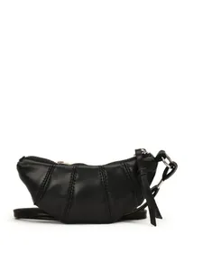 Minimalist black leather croissant crossbody bag with vertical quilted stitching and zipper
