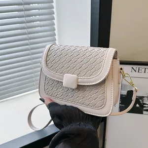 Elegant off-white woven shoulder bag with square buckle and gold hardware strap