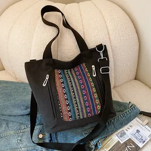 Black canvas tote bag with ethnic embroidery and adjustable strap for women