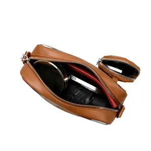 Brown leather crossbody bag showing interior storage for phone and accessories