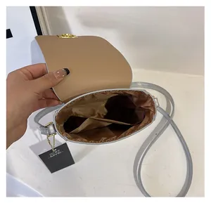 Interior view of mini laser silver crossbody bag showing brown lining and card pocket