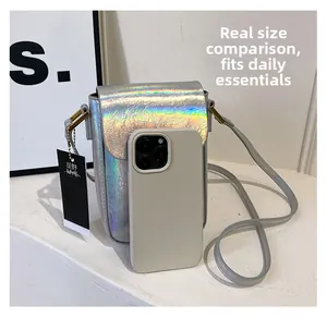 Silver holographic mini crossbody bag detail showing size comparison with a smartphone