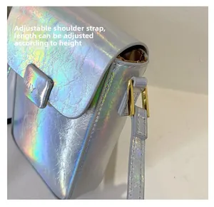 Detail view of silver holographic mini crossbody bag with adjustable shoulder strap