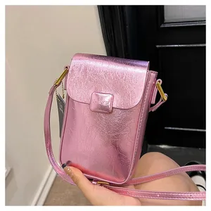 Detail of metallic purple textured mobile phone bag with golden buckle and strap