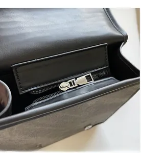 Close-up of smooth silver zipper and interior lining of British style leather backpack