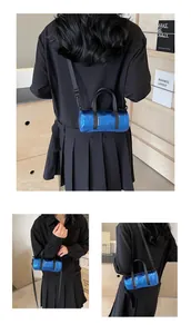 Three-way view of a bright blue metallic barrel bag with black straps on a model
