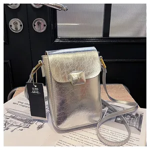 Detail of silver crinkled texture phone bag with magnetic clasp and MIYE logo engraving