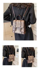 Detail of vintage mini backpack with brown textured finish and metal buckle straps