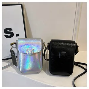 Detail of mini crossbody phone bags with magnetic flap closure and embossed MYE logo