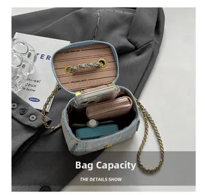 Internal view of denim stripe bucket bag showing capacity for phone and wallet