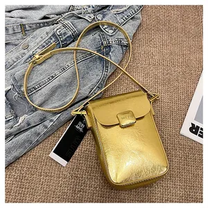 Macro shot of metallic gold mini phone bag featuring wrinkled texture and MIYE logo detail